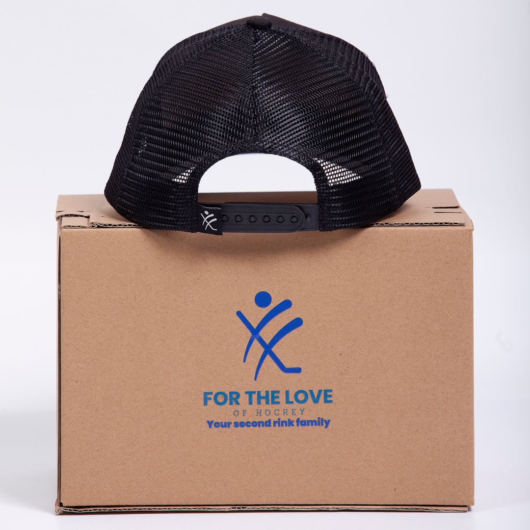 Lets Dangle Hockey Hat Black on Box in Studio